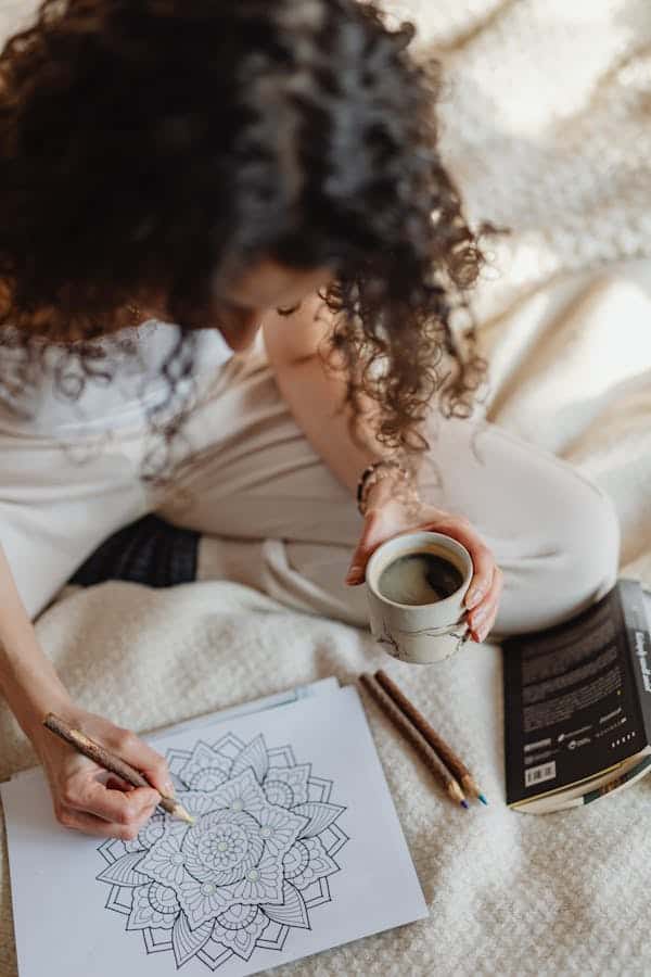 mandala-woman-drawing-sitting-on-bed.