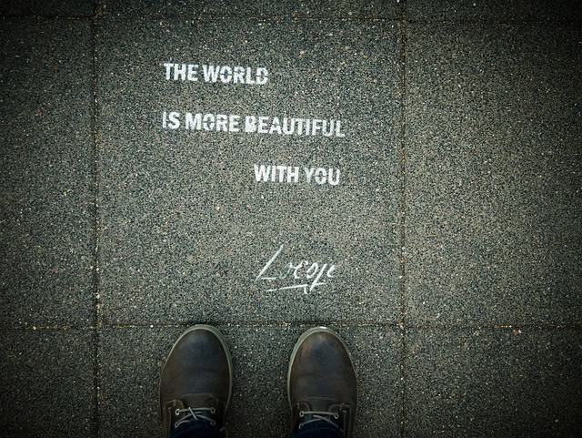 shoes on pavement - white words - The world is more beautiful with you