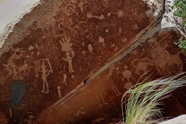 petroglyph-ancient rock painting - figures with tools and animals