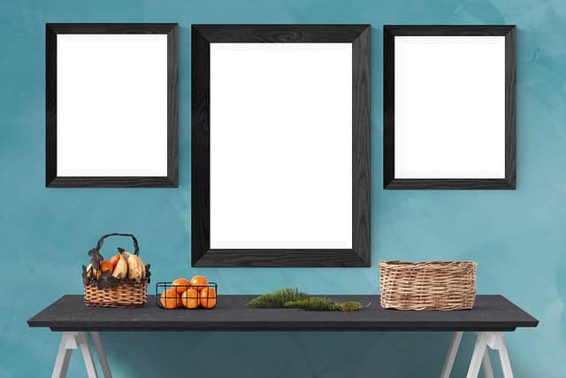 blank-photo-frames-on-wall-above-table.